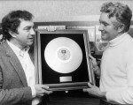 Lionel Long presents one of his gold record awards to NLA archivist Peter Burgis
